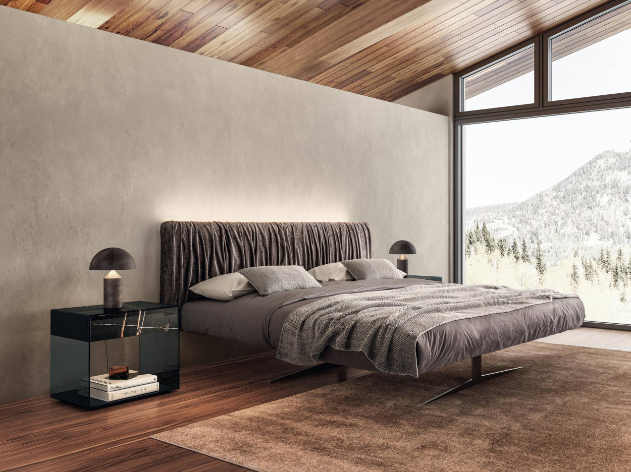 Fotografía interior de una cama moderna y contemporánea con cabecero y  cuadros en las paredes